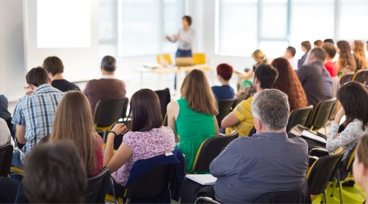 Several parents listening to a speaker at a homeschool convention